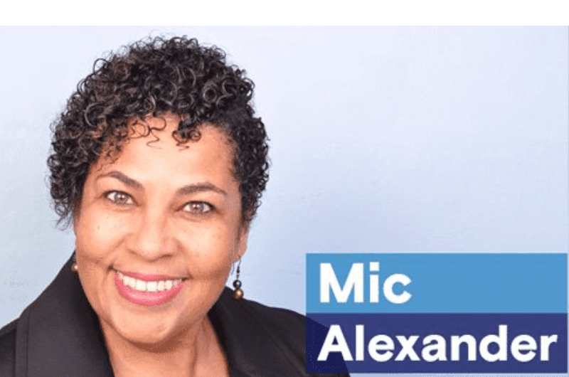 mic alexander a woman with curly hair