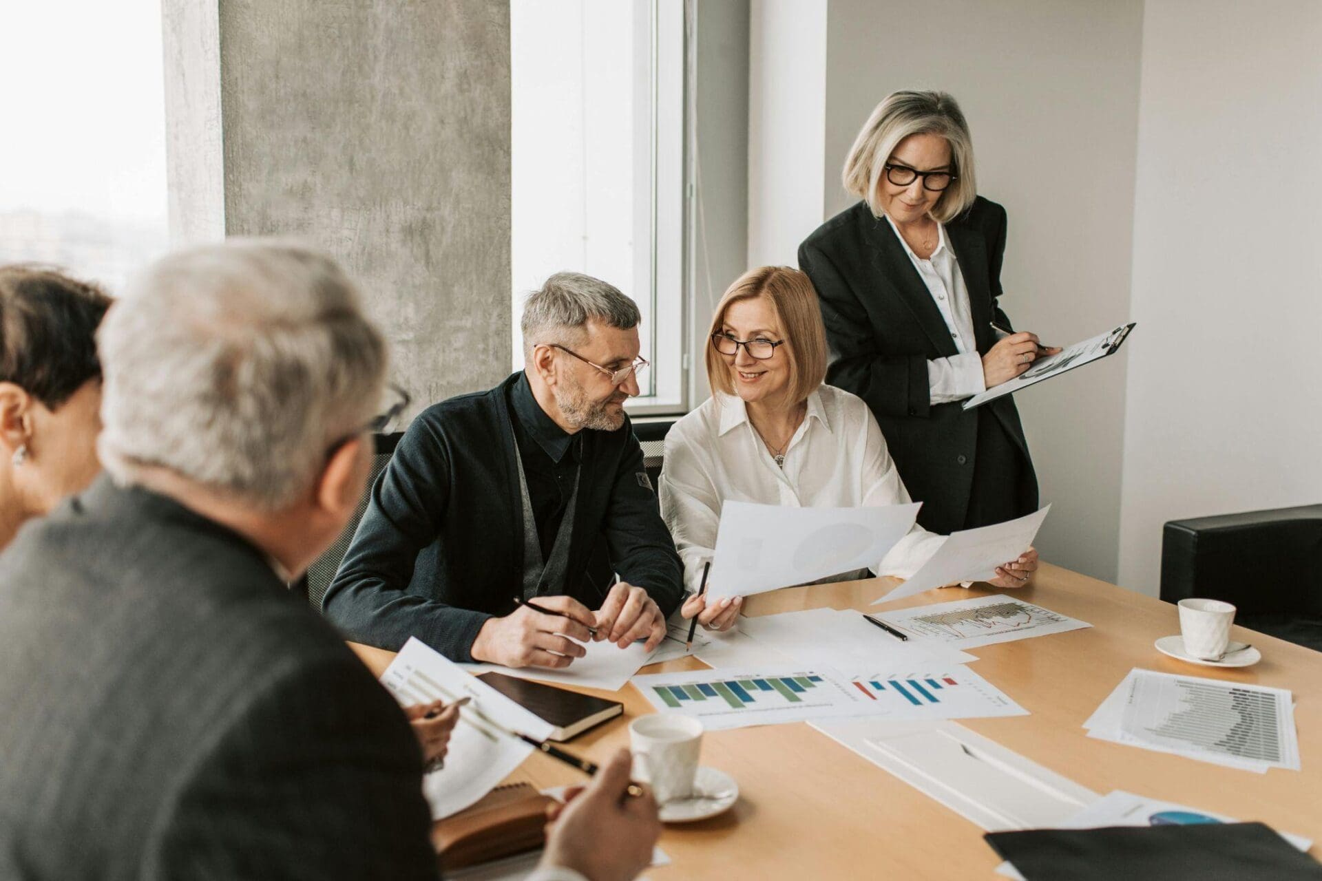 Colleagues looking at documents during a meeting.