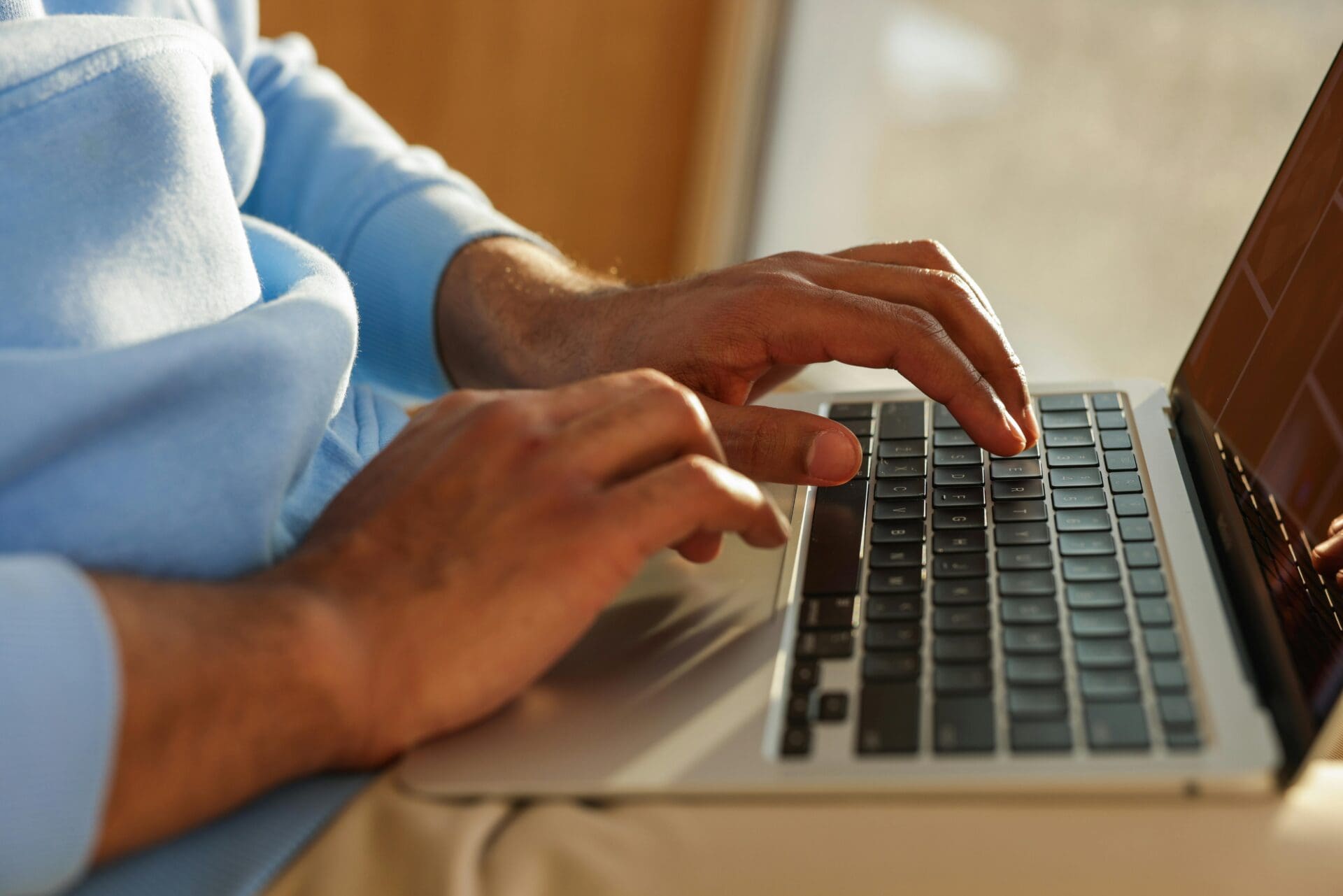 pexels-vazhnik-7864534 A person working on the laptop.