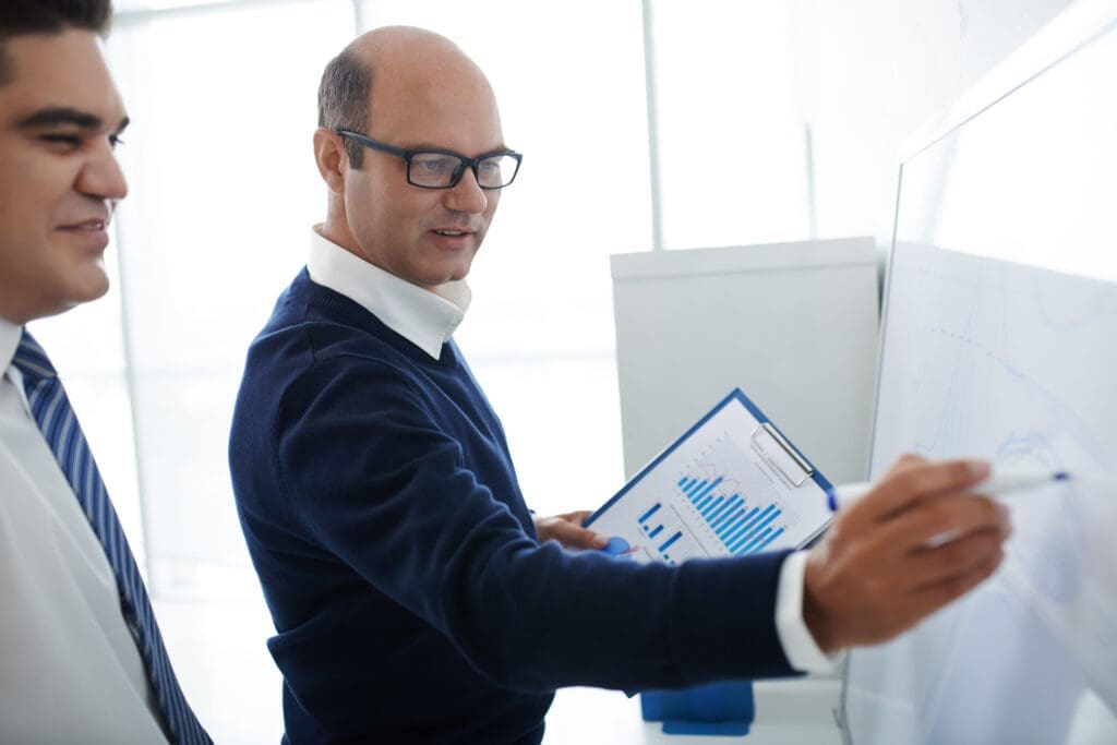 Business people drawing financial chart on the whiteboard
